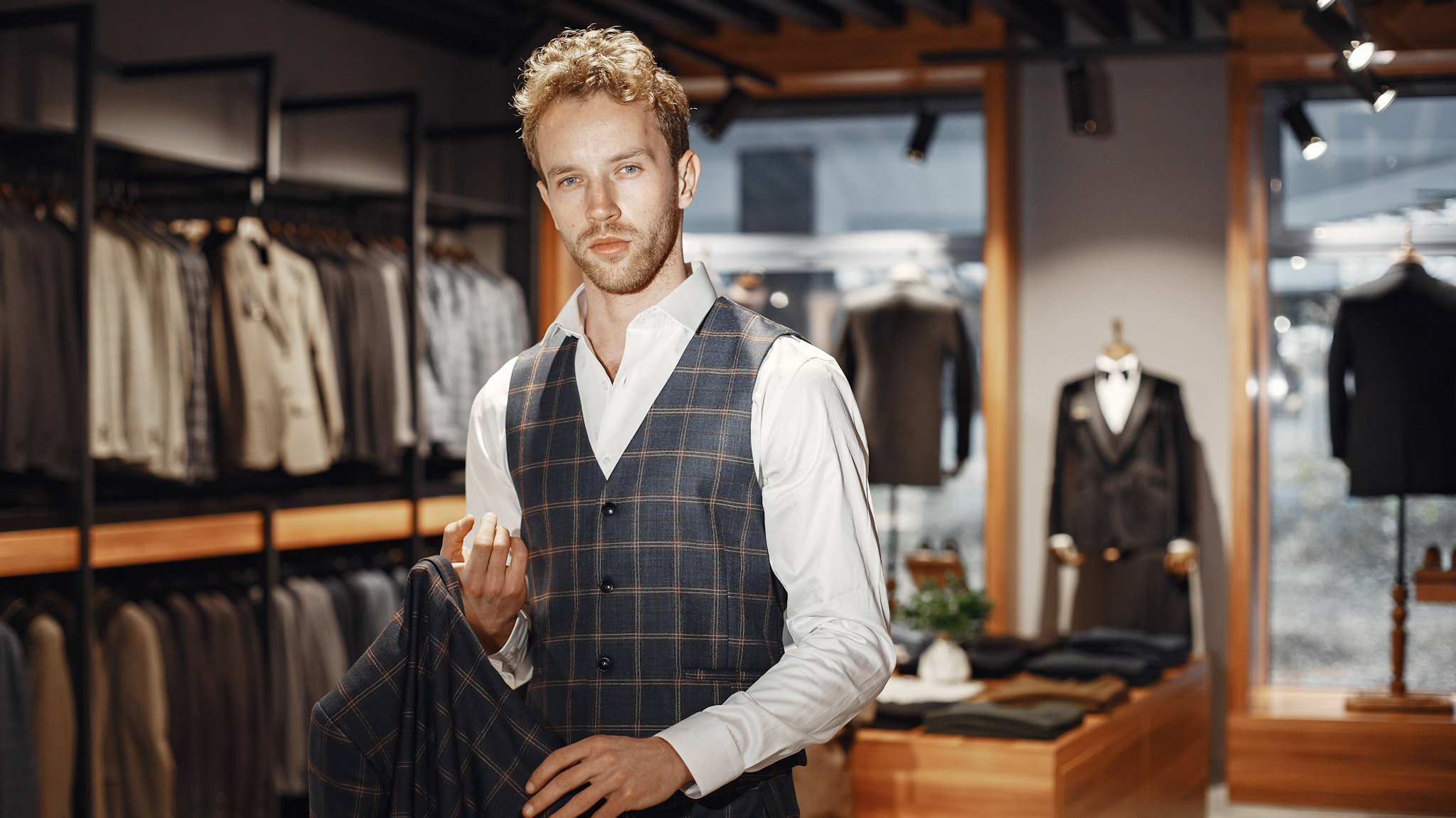 sale shopping fashion style people concept elegant young man choosing clothes mall clothing store