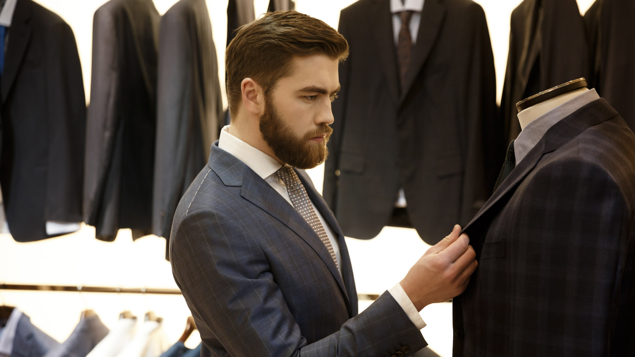 side view man choosing jacket shop